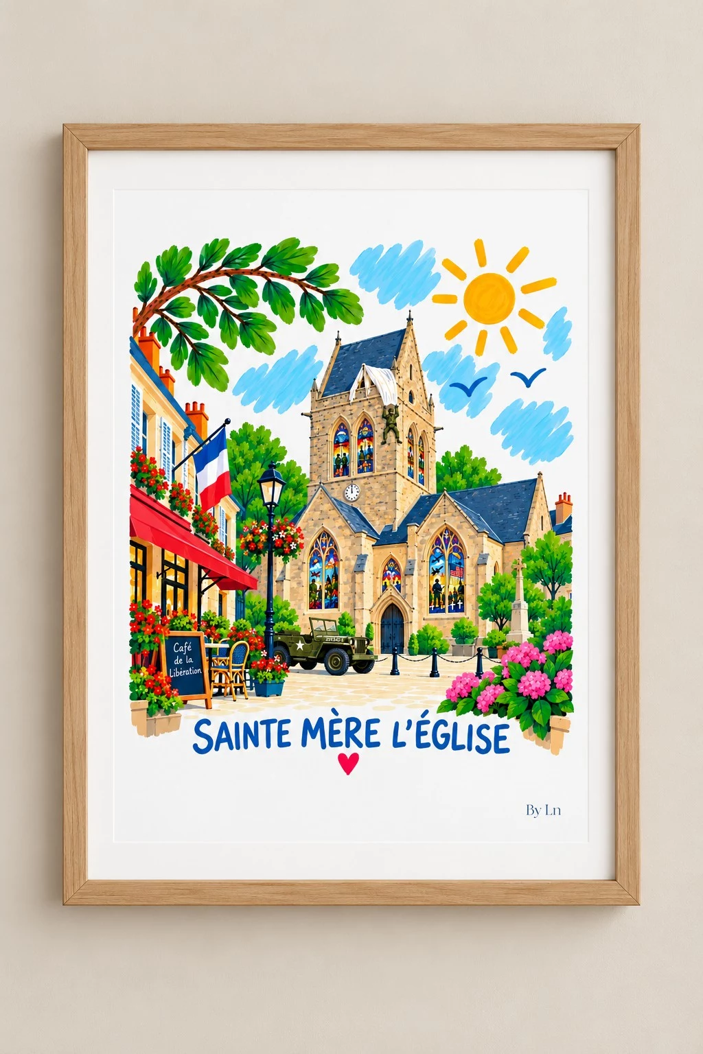 Affiche SAINTE MÈRE L’ÉGLISE illustrée et colorée, présentée dans un cadre en bois clair