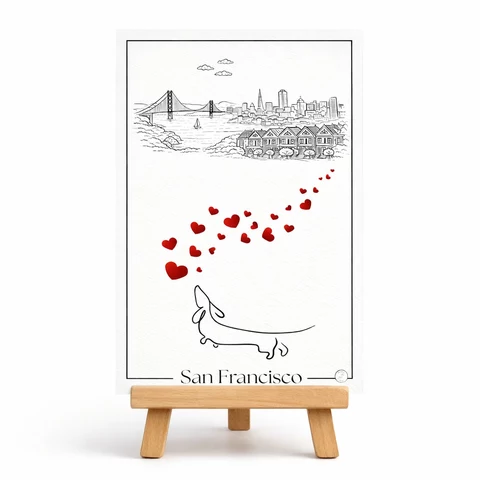 Carte verticale San Francisco en noir et blanc, avec pont suspendu stylisé, maisons alignées, diagonale de cœurs rouges et petit chien en contour.